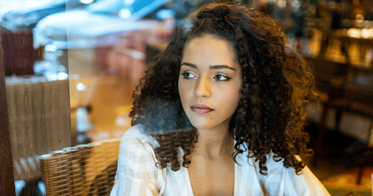 A thoughtful woman considers the symptoms and risks of an ectopic pregnancy.